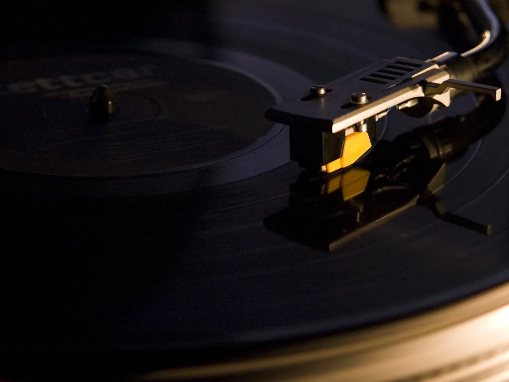 A turntable cartridge on a record in the dark